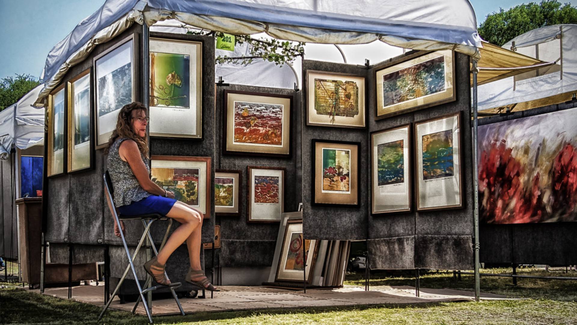 A lively image capturing the vibrant atmosphere of the annual Cottonwood Art Festival, with colorful booths, live music, and creative art displays, symbolizing Richardson's rich cultural scene and artistic heritage.