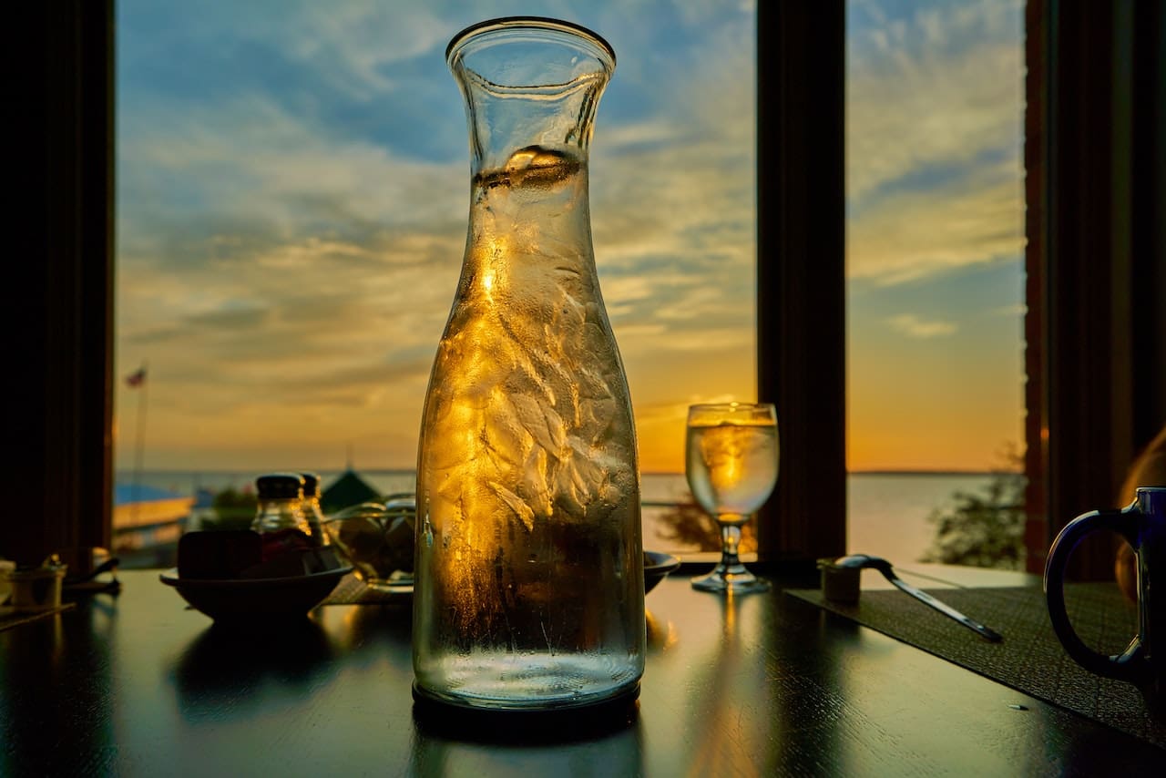 An image of a resident in Fort Worth encountering a cloudy glass of tap water while trying to stay hydrated, highlighting concerns about water quality.