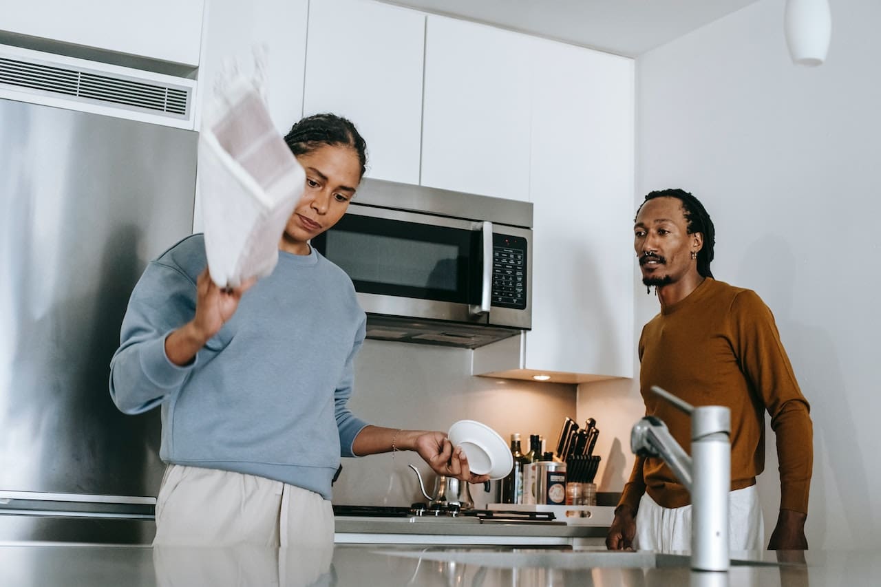 An image of a homeowner frustrated by the buildup of scale and stains in kitchen utensils, emphasizing the need for filtered water for cooking and preventing mineral deposits in Pearland homes.