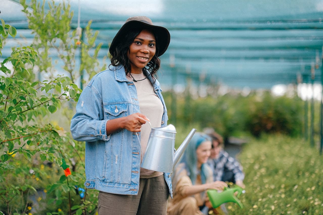 A heartwarming scene of a family watering their colorful garden, using efficient irrigation systems, and enjoying the fruits of their labor, exemplifying the city's commitment to sustainable gardening and outdoor activities.