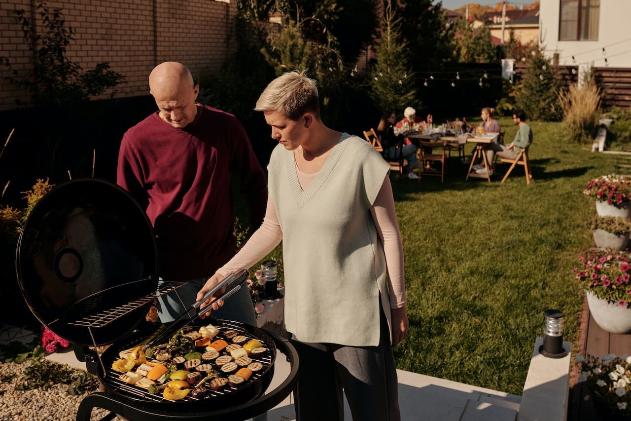 A heartwarming scene of a family enjoying a barbecue in their backyard, under the starry Texas night sky, sipping on refreshing beverages made with pure water, showcasing the warmth of home and outdoor living in Atascocita.