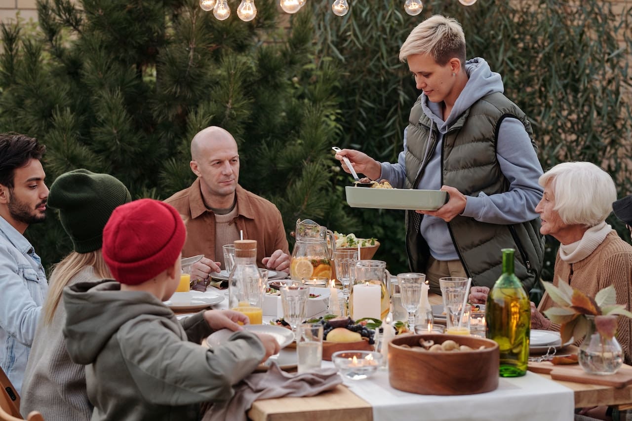 A cozy evening snapshot of friends gathered in their garden, enjoying a barbecue and outdoor games on a sunny day, with cool beverages made from pure water, illustrating the simple pleasures of outdoor living in Richardson.