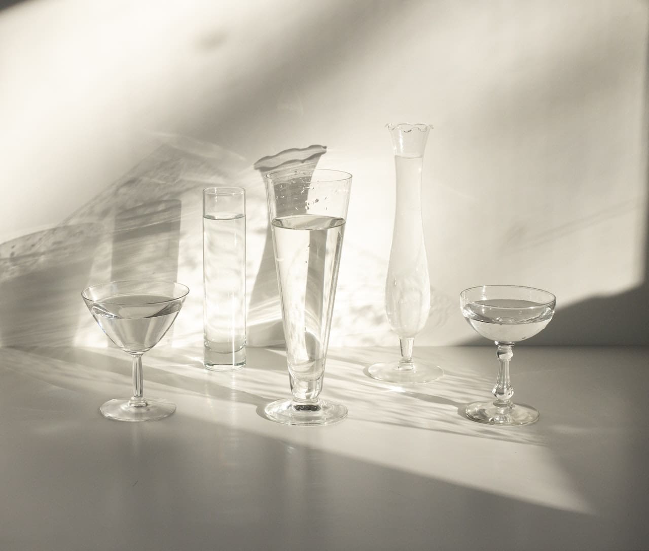 An image of a concerned homeowner inspecting a glass of tap water with visible impurities and sediment, highlighting the importance of clean, filtered water for everyday use in Allen households.