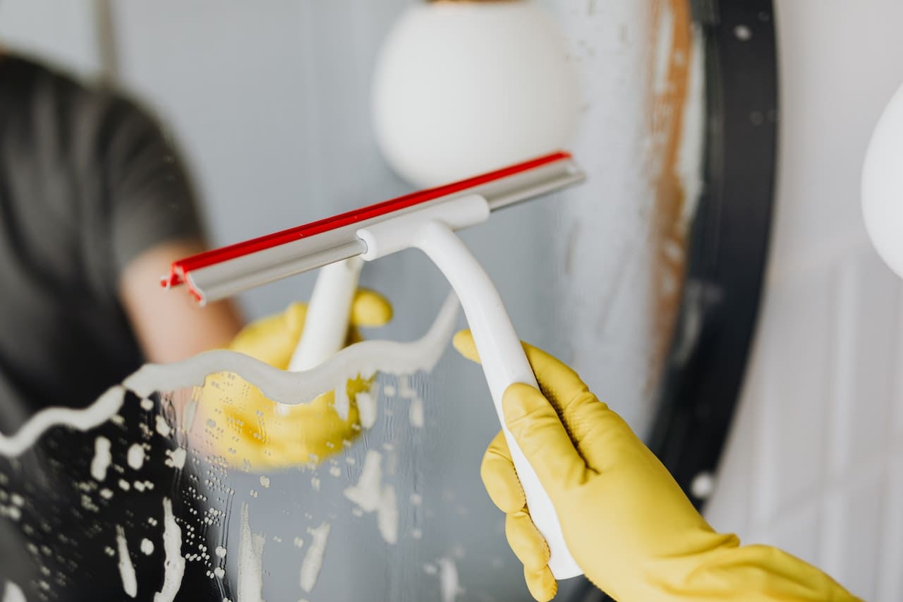 An image of a concerned homeowner inspecting a glass of tap water with visible impurities and sediment, highlighting the importance of clean, filtered water for everyday use in Brownsville households.
