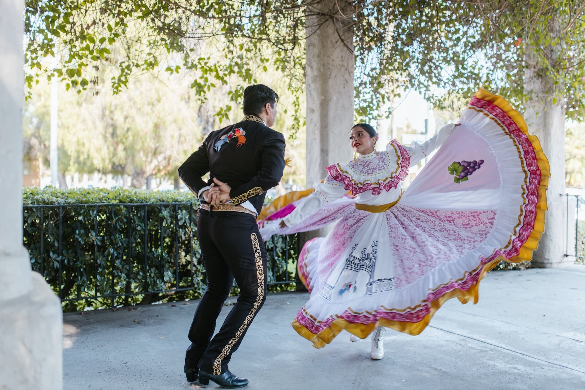 A captivating image capturing the vibrant atmosphere of a traditional Mexican folk dance performance during the annual Fiesta Edinburg, with colorful costumes and lively music, symbolizing Edinburg's rich cultural scene and community celebrations.