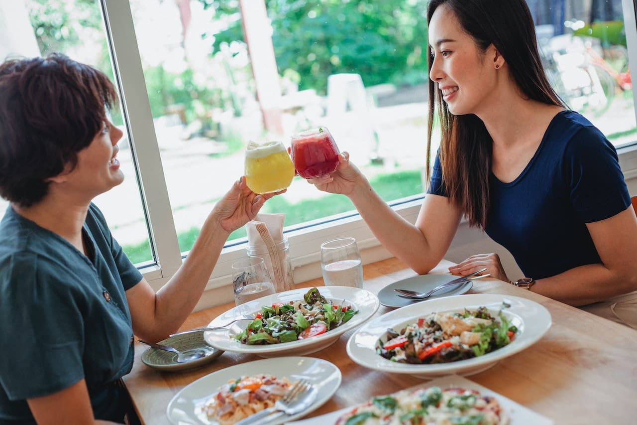 A group of friends toast with tall glasses filled with sparkling water