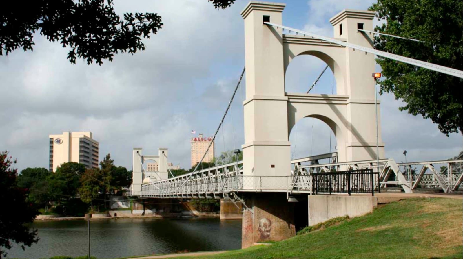 A captivating image of the famous Waco Suspension Bridge, with its historic architecture and vibrant riverfront park, symbolizing Waco's rich history and its modern blend of culture and nature.